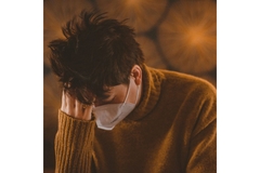 Image Man wearing mask feeling unwell due to Long COVID